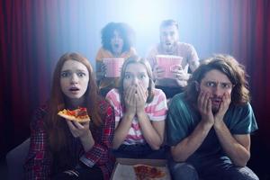 Group of friends watch a film at the cinema photo