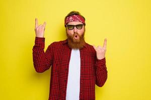 Happy man dances with beard and bandana in head photo