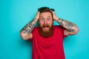 Man with beard is confused and stressed photo