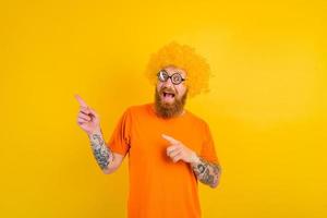 Happy man with beard, yellow wig and glasses photo