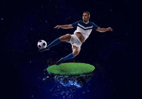 Football player kicks the soccer ball into space photo