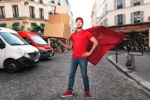 Superhero man with red uniform in front of the shops for delivery and pickup of the goods photo
