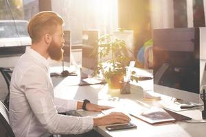 Businessman in office connected on internet network with computer photo