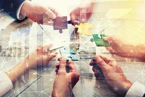 Teamwork of partners. Concept of integration and startup with puzzle pieces. double exposure photo