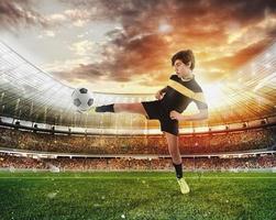 Football scene with competing young football players at the stadium photo