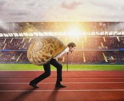 Businessman runs slow like a snail in a runner race photo