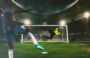 Goalkeeper catches the ball at the stadium during a football game photo