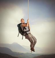 Explorer hanging from a rope photo