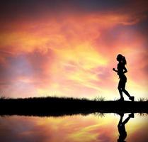 Silhouette of running girl photo