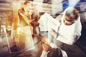 Business people work in the office with statistic worksheets. concept of teamwork and business. double exposure photo