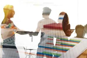 Silhouette of young workers shaking hands in the office. concept of teamwork and partnership. double exposure photo