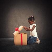 Happy little girl with a Christmas gift photo