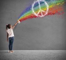 Child draws with spray the color of peace photo