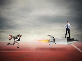 Winner businessman over a fast rocket. Concept of business competition photo