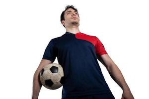 Soccer player ready to play with soccerball at the stadium. Isolated on white background photo