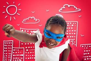 Child acts like a superhero to save the world on red background photo