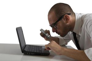 Businessman looks on the computer with a lens photo