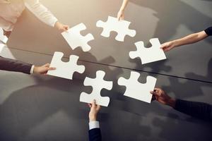 Teamwork of partners. Concept of integration and startup with puzzle pieces photo