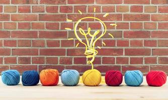 Concept of idea and innovation with wool ball that shapes a lightbulb photo