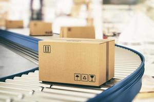 Cardboard boxes on conveyor rollers ready to be shipped by courier for distribution photo