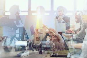 Business people work together drawing a business diagram with marking pen. concept of teamwork, partnership and success. Double exposure photo