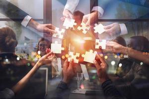 Teamwork of partners. Concept of integration and startup with puzzle pieces. Double exposure photo