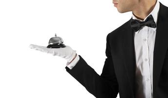 Waiter with bell in hand. Concept of first class service in your business photo