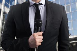 elegant Businessman ready to speak with microphone photo