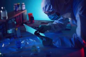 Man with tablet in a medical science laboratory. Concept of virus and bacteria research photo