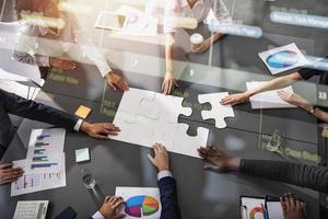 Teamwork of partners. Concept of integration and startup with puzzle pieces photo