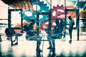 Business team connect pieces of gears. Teamwork, partnership and integration concept. double exposure with network effects photo