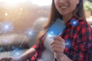 Girl is ready to pay with credit card on an online store photo