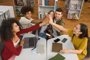 University students are studying in a library together. Concept of teamwork and preparation photo