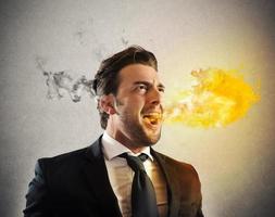 Furious businessman spitting fire photo