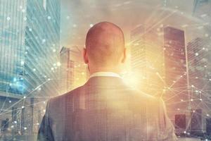 Businessman looks far for the future with internet network effect photo