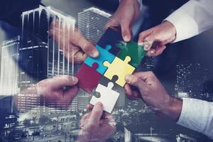 Teamwork of partners. Concept of integration and startup with puzzle pieces. double exposure photo