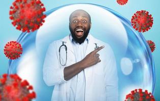 Smiling doctor is happy to win against the coronavirus inside a glass sphere. Cyan background photo