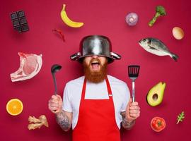 Man chef is ready to fight in the kitchen. burgundies background photo