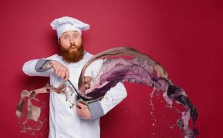 Chef is surprised about a new recipe. burgundy background photo