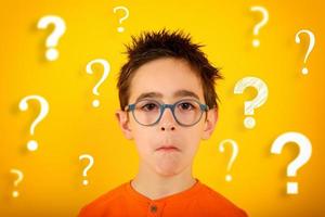 Child is not sure about something and has some questions. yellow background photo