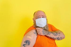 Man with beard and tattoos did the vaccine against covid-19 photo