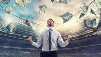 Happy man for winning a sport bet. Rain of money inside a soccer stadium photo