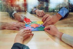 Teamwork of partners connect puzzle pieces as integration and startup photo