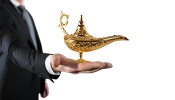 Businessman hold a genie lamp of aladdin. concept of desire and make a wish come true photo