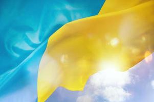 Sunny Ukraine country flag with wave motion of wind photo