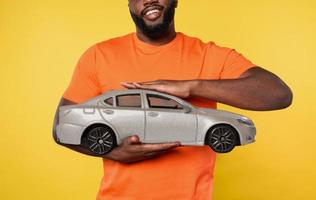 Man holds a small car. concept of buy a new automobile photo