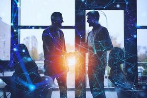 Handshaking business person in office. concept of teamwork and partnership. Internet network effect photo