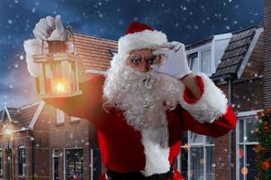 Doubtful santa claus with a vintage lantern photo