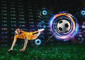 Football striker player jumps with online soccer bet, analytics and statistics background photo