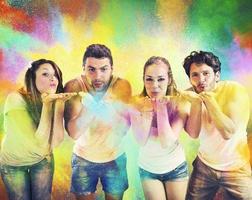 Friends blowing colored powders photo